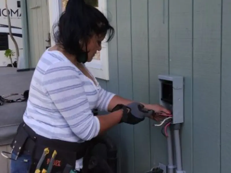 Licensed electrician wiring an exterior subpanel in Flatwoods